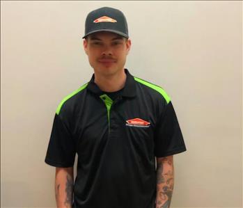 male employee in a SERVPRO shirt and hat