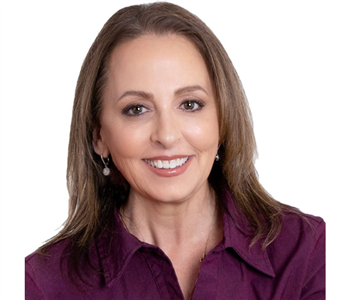 female employee with brown hair wearing a purple shirt