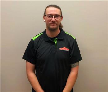 male employee with long hair wearing a SERVPRO shirt