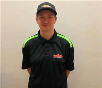 male employee in a SERVPRO shirt and hat