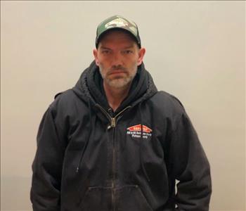 male posing in servpro black jacket