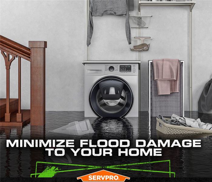 Flooded basement with standing water up to the washing machine and floating laundry basket.